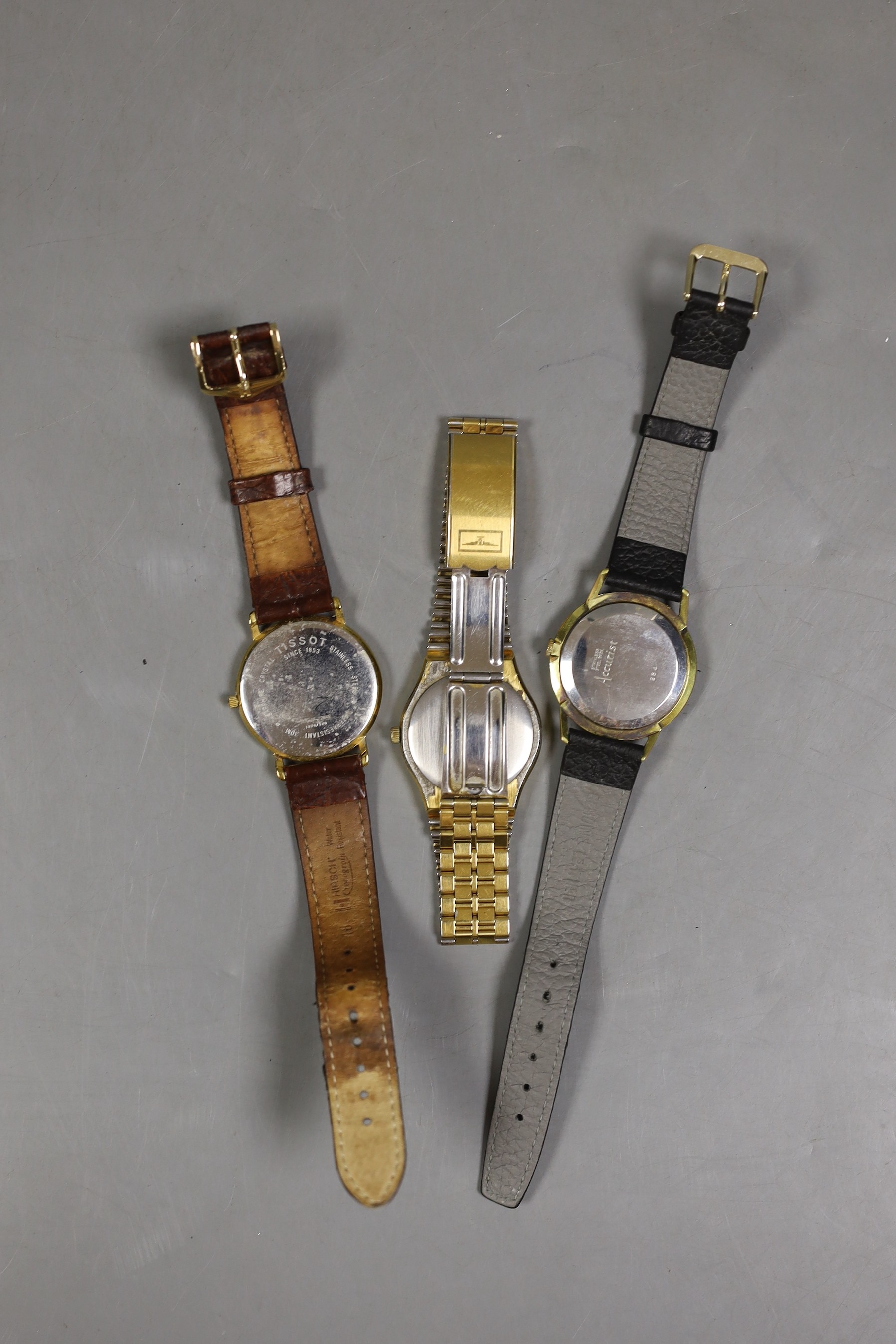Three assorted gentleman's wrist watches, including a steel and gold plated Longines automatic, Tissot and Accurist.